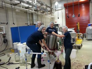 Denise Gardener pressing wine with students at Penn State